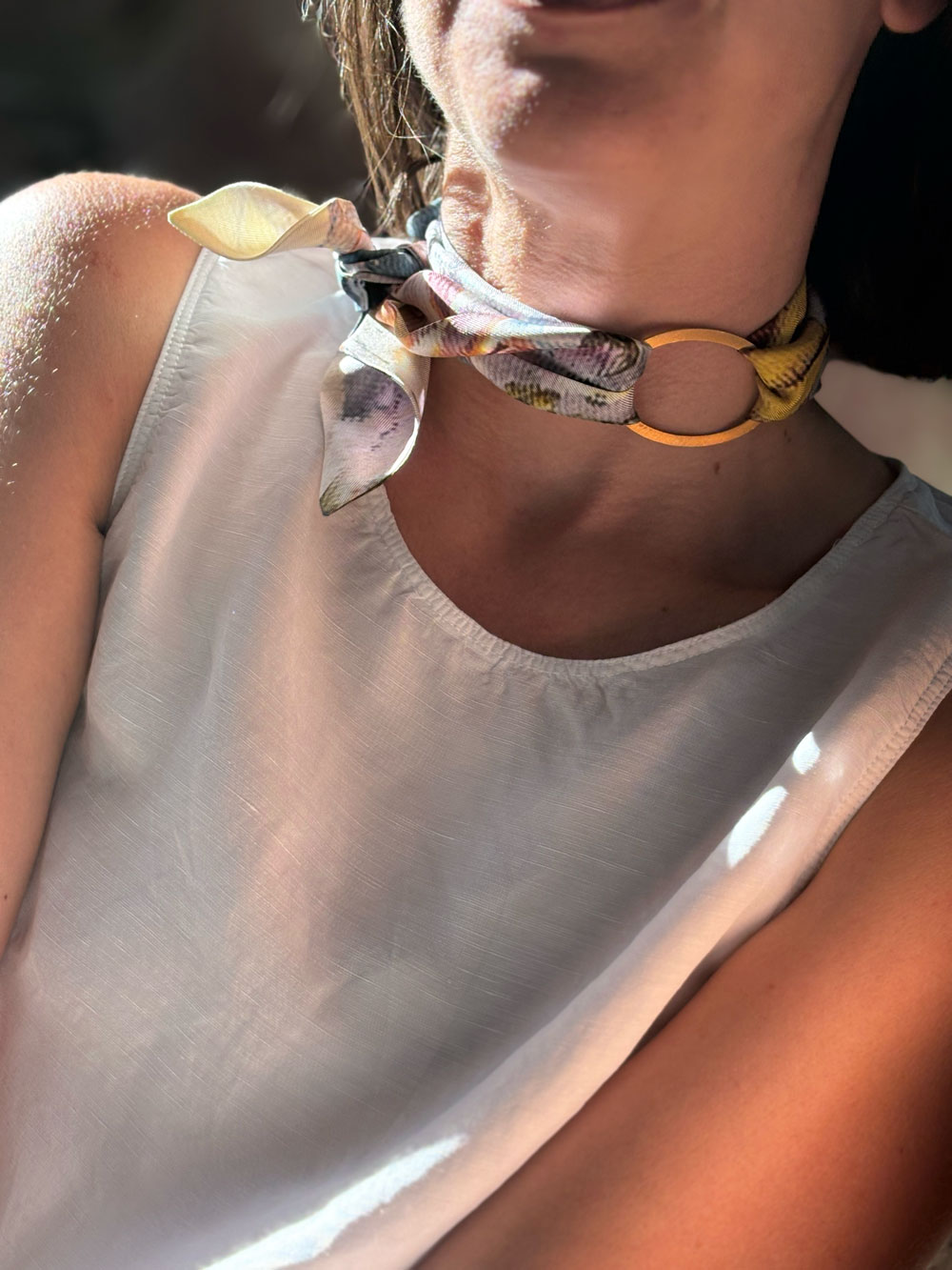 Silk scarf tied around the neck