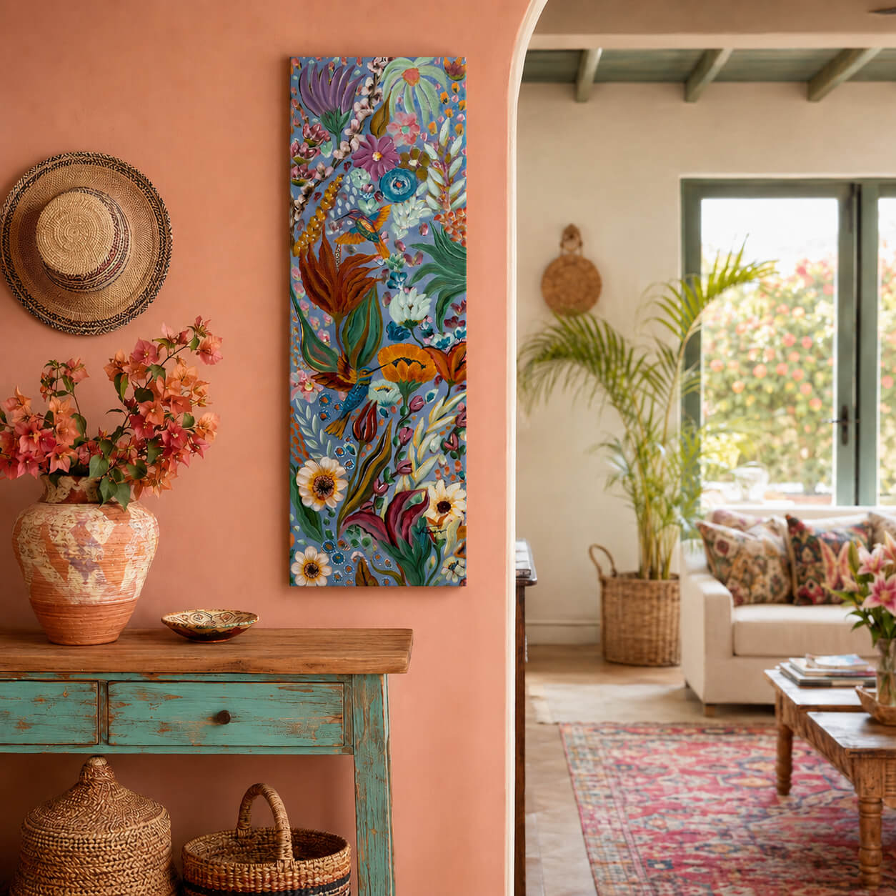A vertical canvas art print featuring a vibrant, colorful bohemian-style floral and bird illustration, displayed on a terracotta-colored wall in a styled living room setting.