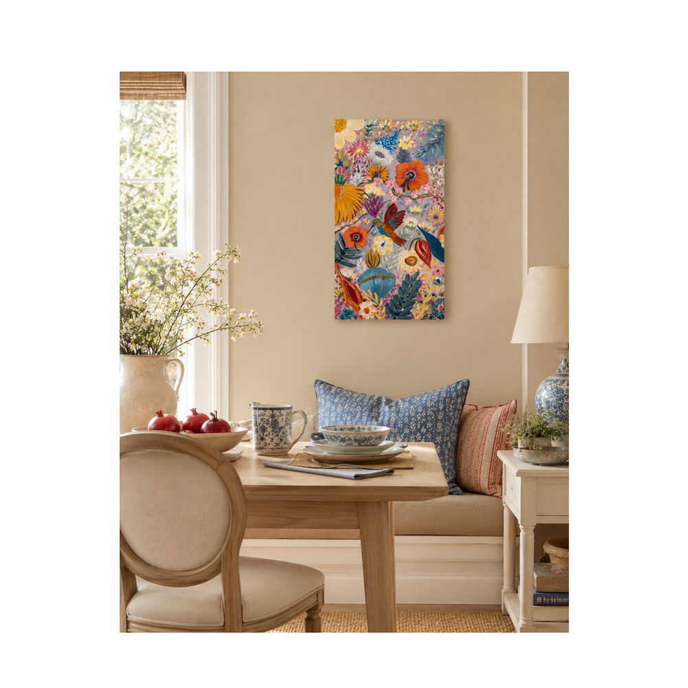 A colorful vertical canvas wall art print featuring a vibrant tropical floral and bird pattern, displayed in a styled dining room setting above a wooden table and bench.