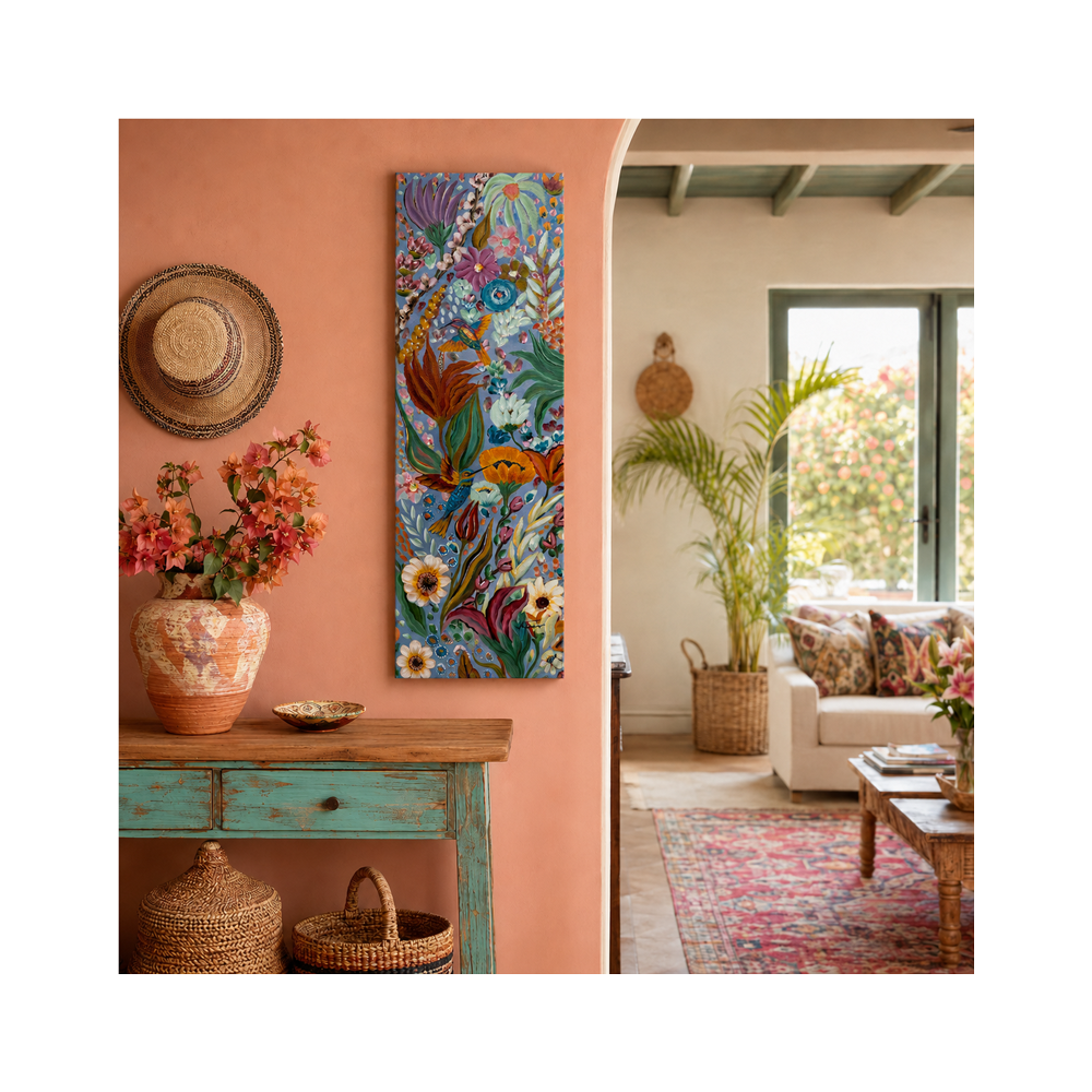 A tall, narrow vertical canvas print featuring a colorful tropical fish and coral reef scene, styled on a terracotta-colored wall in a bohemian living room setting.