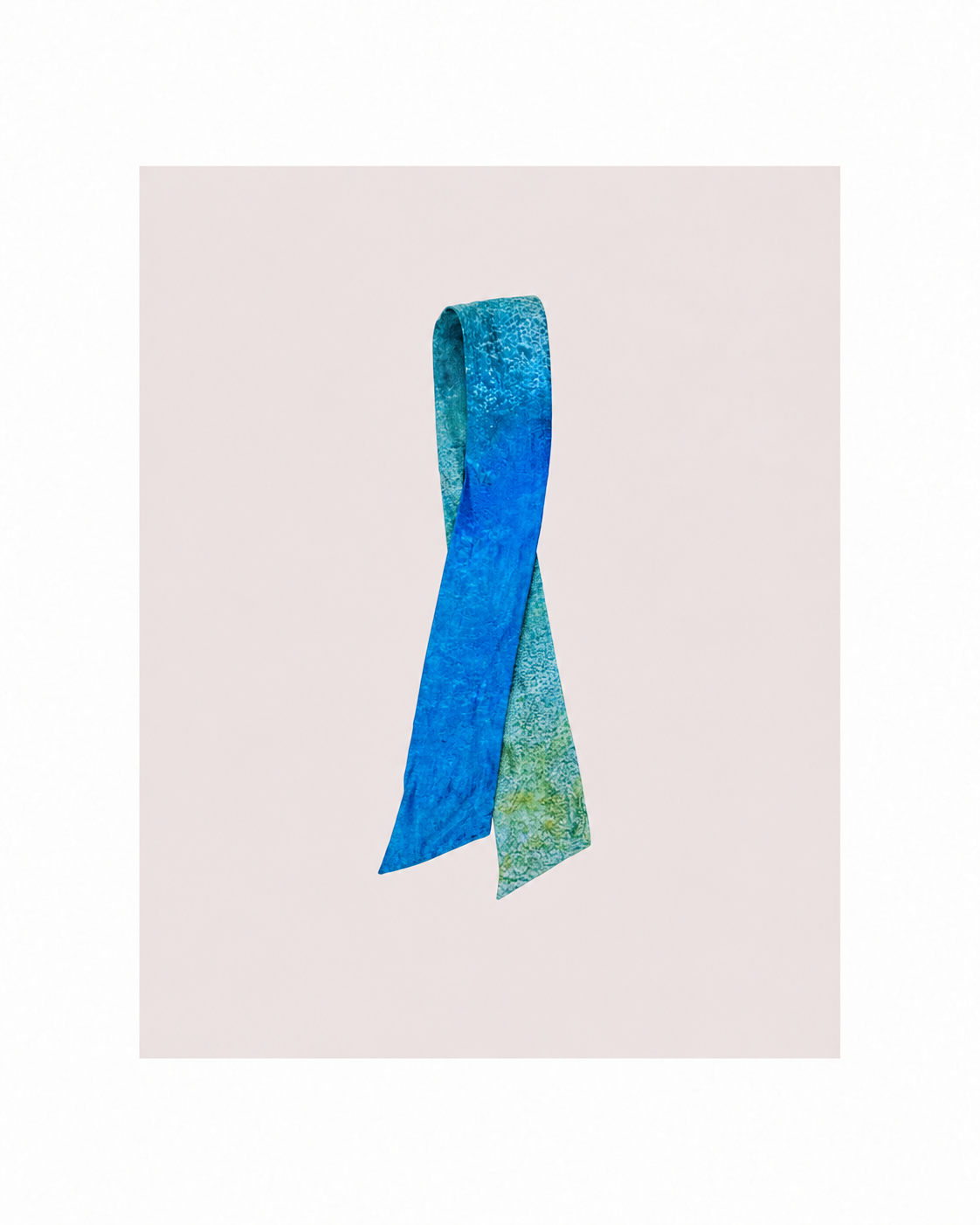 A textured silk necktie with a blue and green abstract pattern, presented on a light beige background.