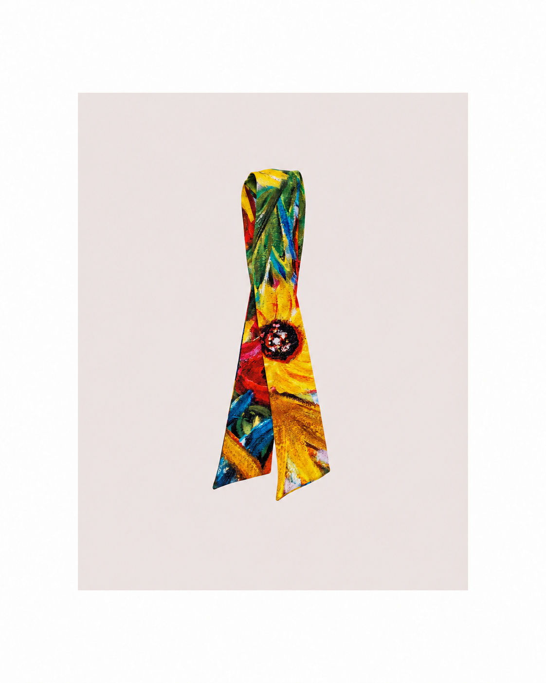 A vibrant silk scarf with a multicolor floral and leaf pattern, tied in a neat loop, displayed against a solid pale pink background.